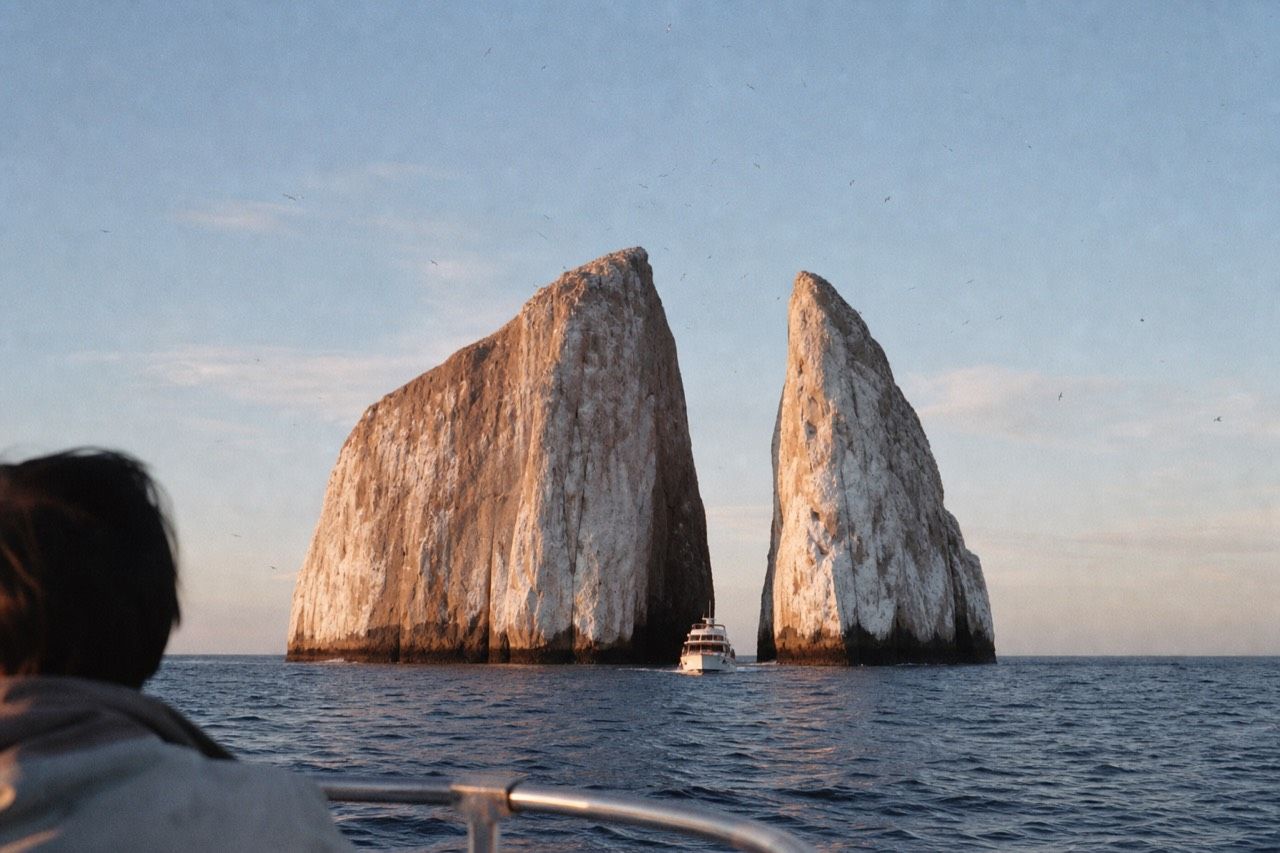 Kicker Rock rising from the sea off San Cristóbal, showing the two eroded tuff formations split by a narrow channel