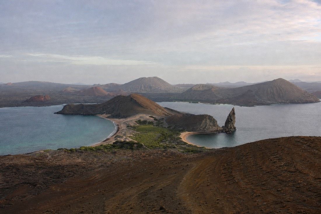 The volcanic pinnacle rock and twin bays of Bartolome Island seen from the summit